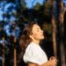 a woman in a white shirt is playing frisbee